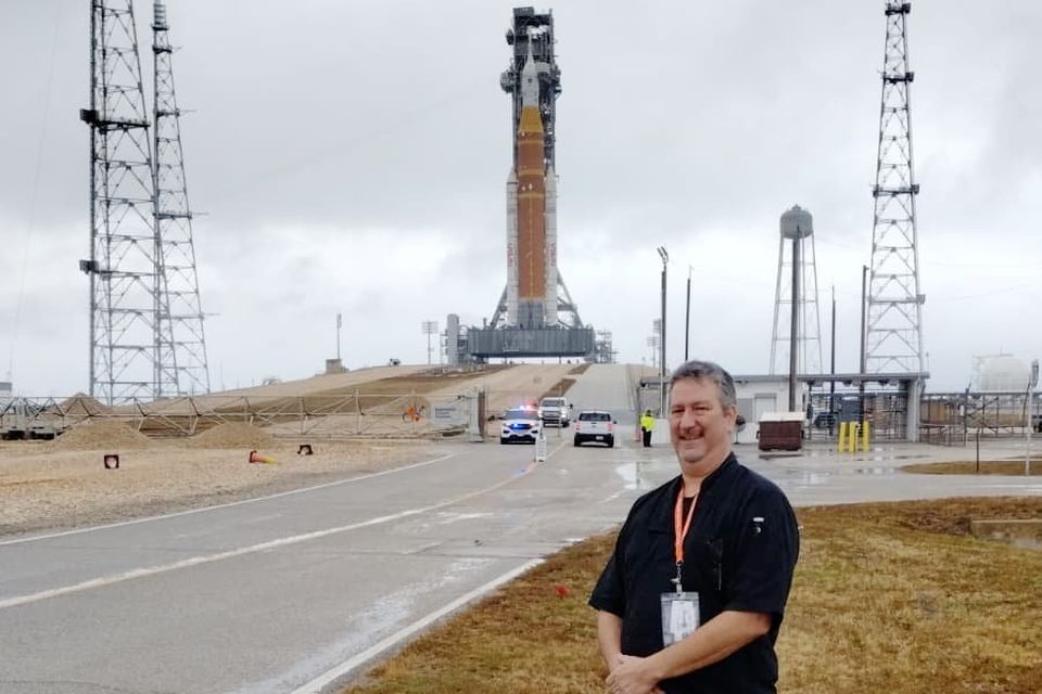 Chef Michael Slintak pictured in front of the Artemis II rocket at the Kennedy Space Center in Florida.